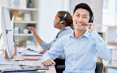 Image showing Portrait, call center and Asian man smile for customer service, telemarketing or tech support. Face, crm and sales agent, consultant or employee coworking at help desk, business office and consulting