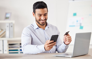 Image showing Businessman, credit card and phone for payment in office with internet for online shopping subscription. Professional asian person at desk for ecommerce safety, budget app or banking information