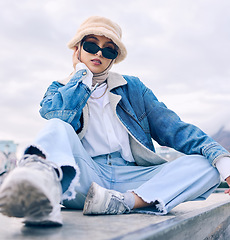 Image showing Portrait, fashion or eyewear with an islamic woman outdoor in a cap and scarf for contemporary style. Muslim, faith or hijab with a trendy young arab female person posing outside in modern sunglasses