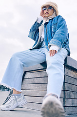 Image showing Portrait, fashion or city life with a muslim woman outdoor in a cap and scarf for contemporary style. Islam, faith and hijab with a trendy young arab female person posing outside in an urban town