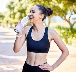 Image showing Happy woman, fitness and laughing with water bottle in rest from fun running, exercise or cardio workout in park. Fit, active or thirsty female person, athlete or runner with smile for sustainability