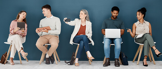 Image showing Hiring, technology and business people waiting for job interview, vacancy and opportunity in office. Recruitment, diversity and men and women on phone, tablet and laptop to prepare for hr meeting