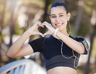 Image showing Runner, heart hands or portrait of happy woman in park for running exercise or workout for body health. Love sign, hand gesture or active girl athlete runner in sports training for fitness in nature