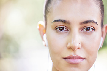 Image showing Face portrait, runner or woman with earphones for music to start training, workout or running exercise in park. Serious, healthy or sports girl athlete listening to radio or podcast about fitness