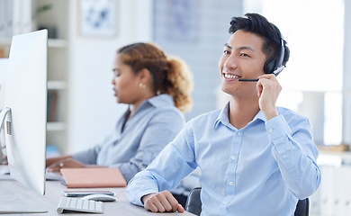 Image showing Call center, smile and asian man in office for customer support, advice and friendly service. happy, telemarketing and male consultant online for help, support or crm, faq or contact us communication