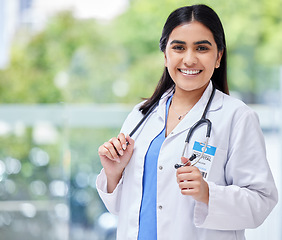 Image showing Young woman, doctor and hospital portrait with smile, stethoscope and healthcare career with pride. Female latino medic, happy health and wellness expert with medical job, clinic and help in services