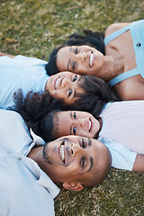 Image showing Family, happy portrait and lying on grass in garden with mother, father and kids together with love. Face, top view and dad with mom and children with parent support and care on a lawn with smile
