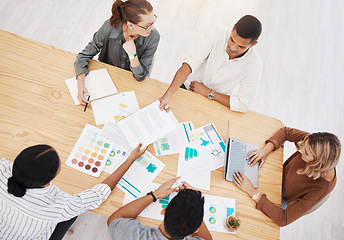 Image showing Diversity, top view of colleagues planning and brainstorming together with paperwork on a table at their workplace. Collaboration or teamwork, ideas or strategy and coworkers working with lens flare