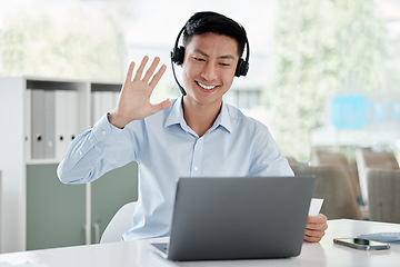 Image showing Asian man, laptop and video call in call center, customer service or virtual assistant at the office. Happy male person or consultant agent waving hello on computer for online advice at the workplace