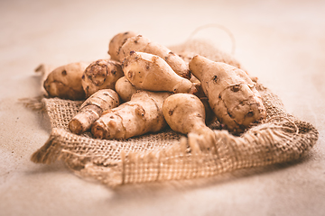 Image showing Fresh organic topinambur on wooden background