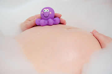 Image showing Pregnant woman in bath with toy