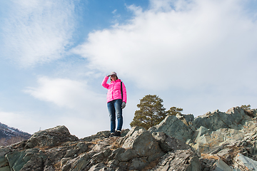 Image showing Happy woman relaxing on the top of mountain