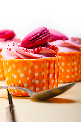 Image showing pink berry cream cupcake with macaroon on top