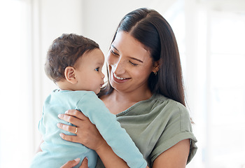 Image showing Smile, mother and holding baby in home for love, care and quality time together for childcare, development and growth. Mom carrying infant kid, newborn girl and support of comfort, bond and happiness