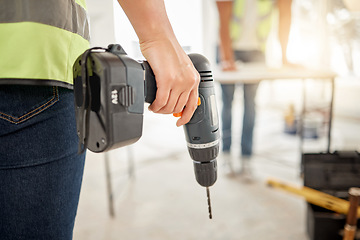 Image showing Drill, construction and hand of handyman for home renovation, maintenance or carpenter work. Back of engineer, constructor or contractor person with electric power tools in room or building site