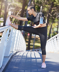 Image showing Woman, stretching legs and bridge in park for fitness, health and warm up for running, outdoor and training. Girl, runner and muscle exercise for body, performance and wellness in summer sunshine