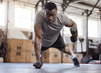 Image showing Dumbbells, push up and exercise with a black man at gym for fitness, training workout and strong muscle. Serious African athlete or bodybuilder person with weights for power, focus and performance