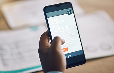 Image showing Phone, research and strategy with a business man at a desk in his office for work while planning growth. Hand, mobile and internet with a male employee reading information or data online closeup