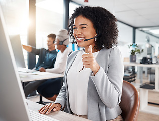 Image showing Call centre, woman and thumb up for online support with smile for success with headset, computer. Customer service, telemarketing and worker is happy with hand gesture for motivation and agreement.