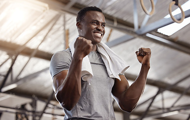 Image showing Goals, success and fitness with a man at gym for exercise, training workout and strong muscle. African athlete or bodybuilder person celebrating with fist for power challenge win or achievement