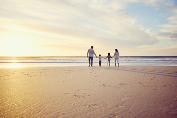 Image showing Sunset, travel and family holding hands on beach walking on holiday, summer vacation and weekend. Nature, mockup and mother, father and children by ocean for bonding, adventure and quality time