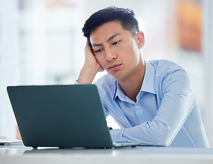 Image showing Mental health, businessman tired and worried a with laptop at his desk in a modern workplace office. Fatigue or burnout, problem or mistake and male person sad or stress at his workstation at work