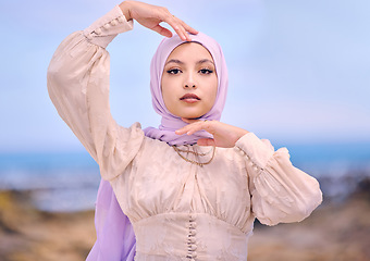 Image showing Portrait, fashion or faith with a saudi woman outdoor in a scarf for religion or contemporary style. Islam, face or hijab with a trendy young muslim person posing outside in nature for modern clothes