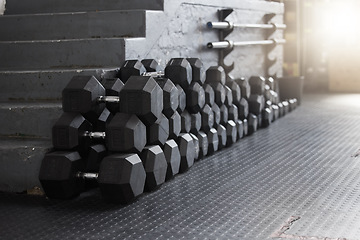 Image showing Equipment, gym weights and floor of room or empty facility for fitness, sports and exercise club mockup. Dumbbells, barbell stack and weight rack in a dark training gymnasium for workout class