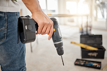 Image showing Drill, handyman and hand of a man at construction site for maintenance or carpenter work. Back of male engineer, constructor or contractor worker with electric power tools in building for renovation