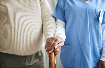Image showing Nurse, holding hands and senior patient with a cane for support, healthcare and kindness at nursing home. Person, caregiver and woman together for trust, elderly care and help in retirement