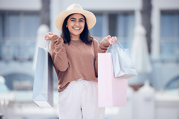 Image showing Woman in portrait, shopping bag and retail at outdoor mall, smile with purchase, luxury and shop discount. Happy female customer, fashion designer brand and buyer choice with store promotion and sale