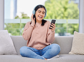 Image showing Woman, headphones and phone for singing on sofa for happiness, relax and sound in home living room. Girl, smartphone and audio streaming subscription for hip hop, rock or edm on lounge couch in house