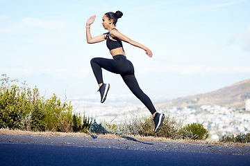 Image showing Woman, fitness and running jump on mountain for exercise, workout or cardio training in nature. Fit, active and sport female person, athlete or runner jumping in sports motivation on mockup space