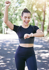 Image showing Success, happy woman or athlete with smart watch in park for heart rate, training performance or exercise goals. Excited, yes or healthy sports girl with timer celebrates running workout or fitness