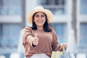 Image showing Happy woman, shopping bag and thumbs up for winning, discount or sale in city outdoors. Portrait of excited female person or shopper with thumb emoji, yes sign or like for luxury sales in urban town