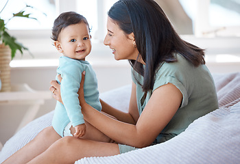 Image showing Happy, mother and holding with baby on lap in home for love, care and quality time together for play, growth and development. Mom, infant and bond with newborn girl kid on bean bag in nursery room