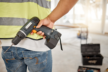 Image showing Construction, handyman and drill in hand of a man for maintenance or carpenter work. Back of male engineer, constructor or contractor worker with electric power tools at building site for renovation