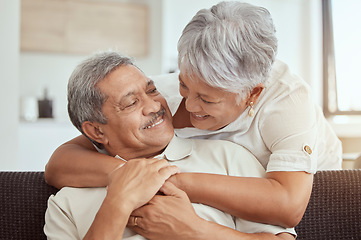 Image showing Love, hug and elderly couple on a sofa, happy and relax, laughing and talking their home together. Embrace, smile and senior man with woman on couch in a living room, cheerful and enjoying retirement