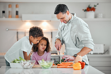 Image showing Cooking, help and meal prep with family in kitchen for health, nutrition and food. Diet, support and dinner with man and children cutting vegetables at home for wellness, organic salad and learning