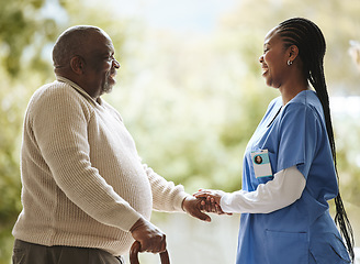 Image showing Senior man, caregiver and holding hands for support, healthcare and happiness at retirement home. Elderly patient and black woman or nurse together for trust, hope and help for health and wellness