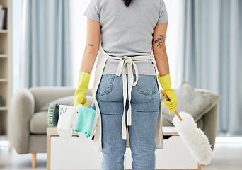 Image showing Woman, housekeeper and back with supplies for cleaning, hygiene or disinfection in living room at home. Rear view of female person, cleaner or maid with clean equipment or tools for dirt or dust