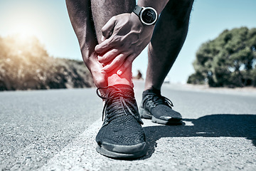 Image showing Fitness, ankle and accident with a sports man holding his joint in pain while outdoor for a workout. Exercise, anatomy and injury with a male athlete feeling tender while training for recreation