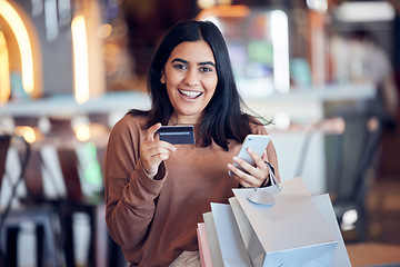 Image showing Portrait, bags and woman with credit card, smartphone and shopping with boutique clothes, retail and shopping. Face, female person and customer in a store, smile and cellphone with payment and sales