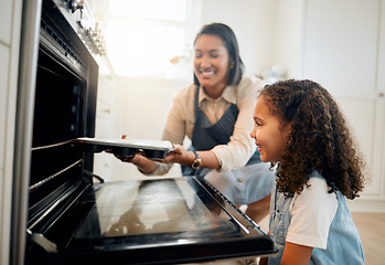 Image showing Mother, oven or child baking in kitchen as a happy family with young girl learning cookies recipe. Mixing cake, daughter or mom smiling, helping or teaching kid to bake with tray for development