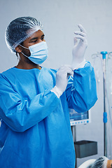 Image showing Doctor in surgery, man in healthcare and surgical procedure start with PPE for safety in operation theatre in hospital. Medical professional, health insurance and male surgeon in protection gear