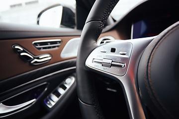 Image showing Control buttons on steering wheel. Car interior.