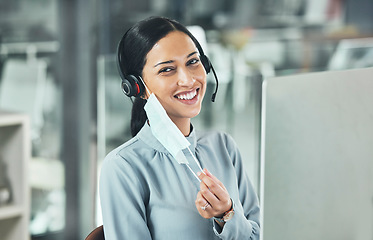 Image showing Customer service, woman call center agent with face mask and headset at her computer in her modern office. Telemarketing or networking, online communication or crm and female person for support