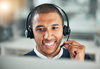 Image showing Face, call center and a man with a headset at computer for customer service or sales. Smile of african person at a pc and talking on microphone as telemarketing, crm support or help desk consultant