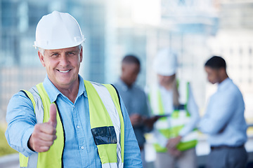 Image showing Portrait, thumbs up and a senior man construction worker outdoor on a building site with his team in the background. Management, motivation and support with a mature male architect saying thank you