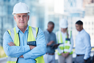 Image showing Portrait, arms crossed and a serious man construction worker outdoor on a building site with his team in the background. Management, leadership and confidence with a senior architect standing outside